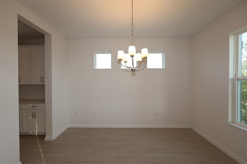 5426 Park Guell Street St. Cloud, FL 34771 - Photo 22 of 64 an empty room with windows and entrance