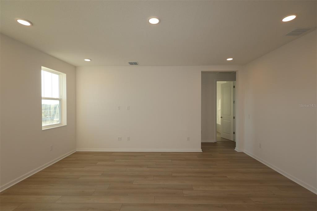 5426 Park Guell Street St. Cloud, FL 34771 - Photo 30 of 64 an empty room with wooden floor and window