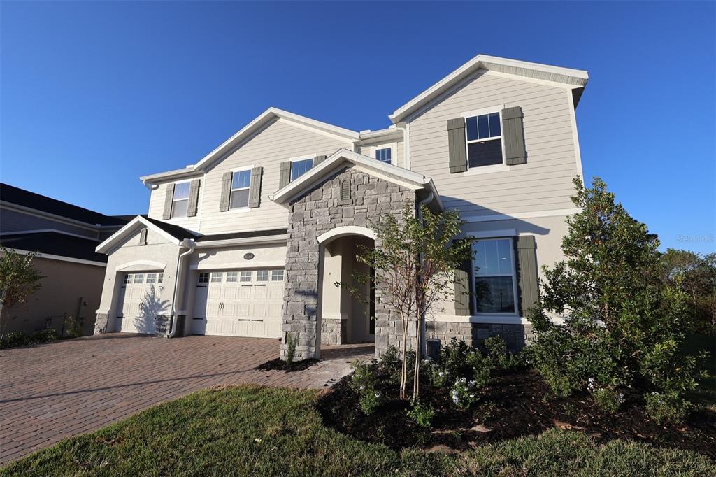 5426 Park Guell Street St. Cloud, FL 34771 - Photo 3 of 64 a front view of a house with a yard and garage