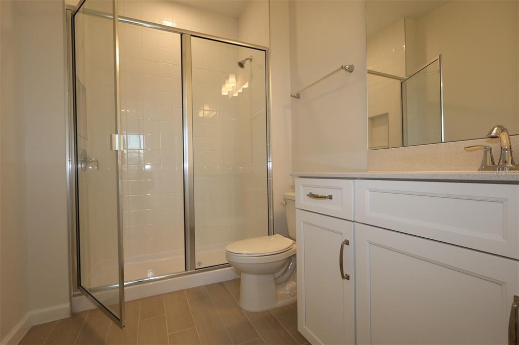 5426 Park Guell Street St. Cloud, FL 34771 - Photo 36 of 64 a bathroom with a shower a toilet and sink