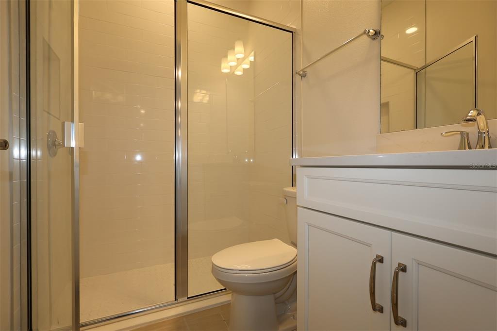 5426 Park Guell Street St. Cloud, FL 34771 - Photo 39 of 64 a bathroom with a toilet a sink and shower