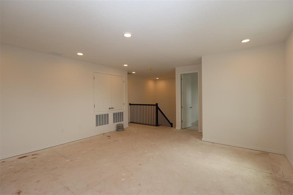 5426 Park Guell Street St. Cloud, FL 34771 - Photo 41 of 64 a view of an empty room with wooden floor