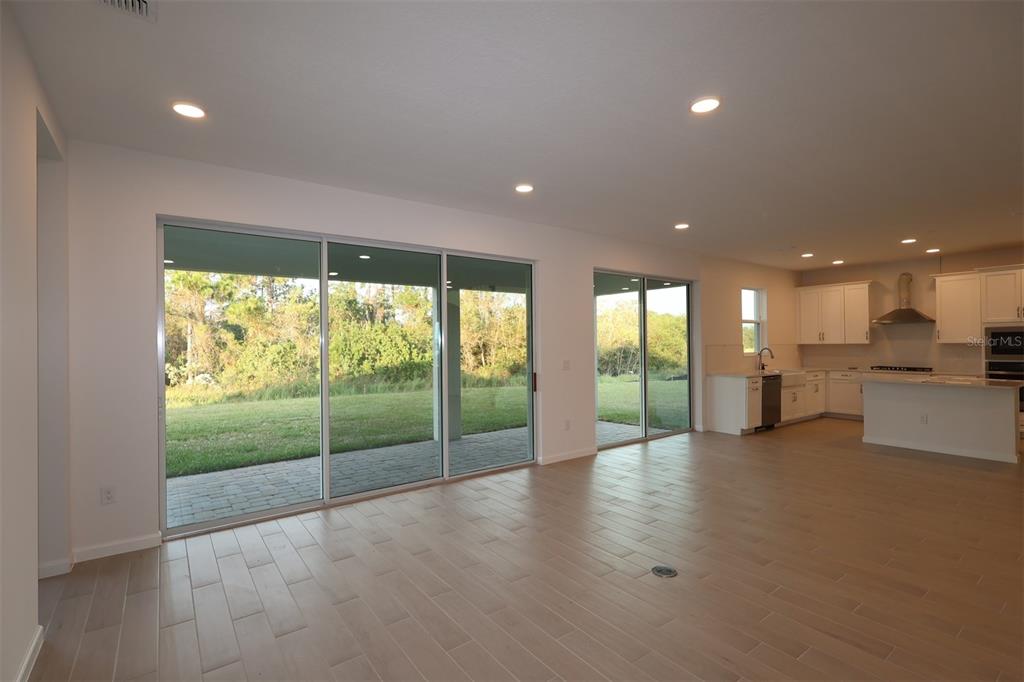 5426 Park Guell Street St. Cloud, FL 34771 - Photo 42 of 64 a view of an empty room with window and wooden floor