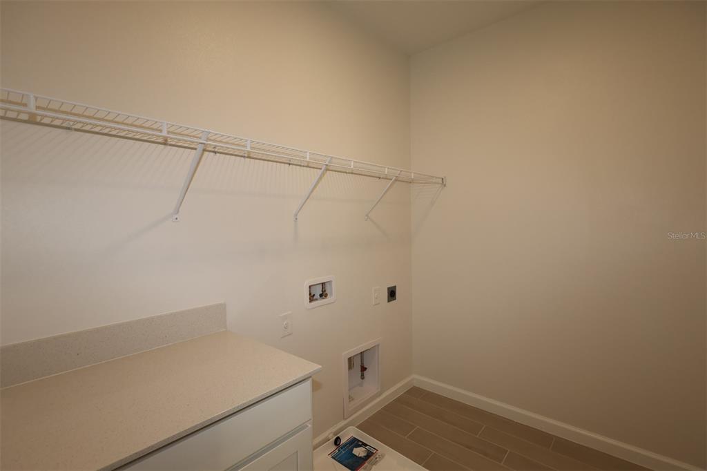 5426 Park Guell Street St. Cloud, FL 34771 - Photo 48 of 64 a bathroom with a sink and vanity