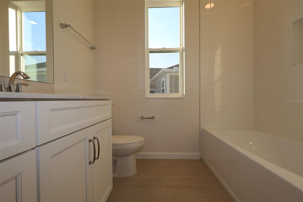 5426 Park Guell Street St. Cloud, FL 34771 - Photo 49 of 64 a bathroom with a sink a toilet and a bathtub