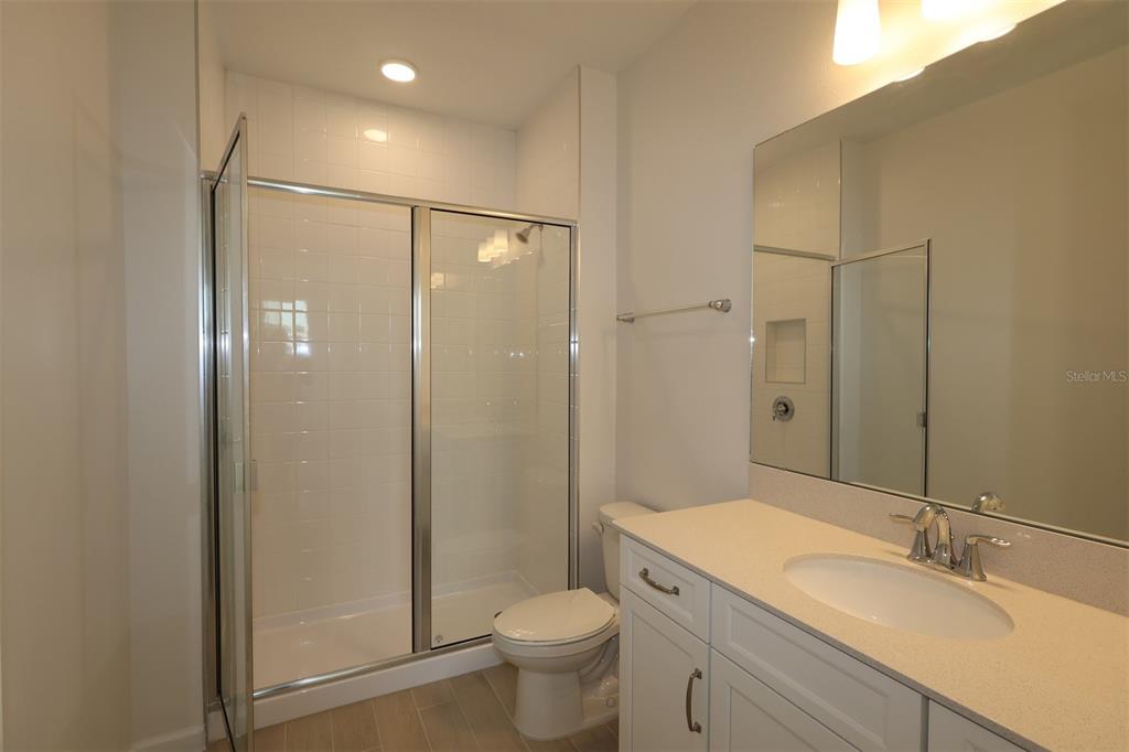 5426 Park Guell Street St. Cloud, FL 34771 - Photo 52 of 64 a bathroom with a granite countertop sink toilet and shower