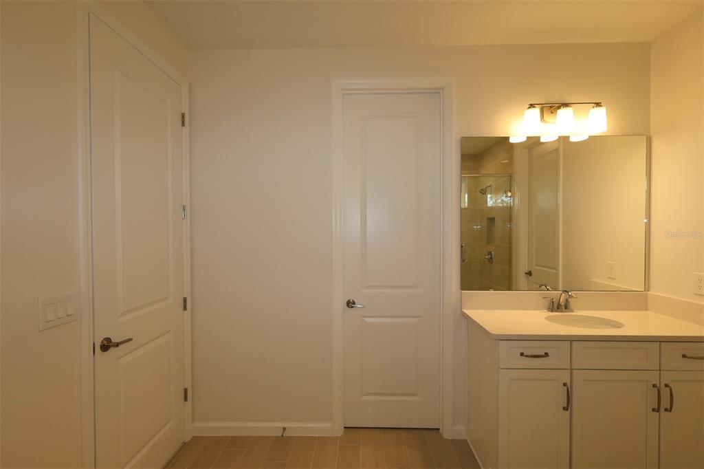 5426 Park Guell Street St. Cloud, FL 34771 - Photo 54 of 64 a bathroom with a double vanity sink and a mirror