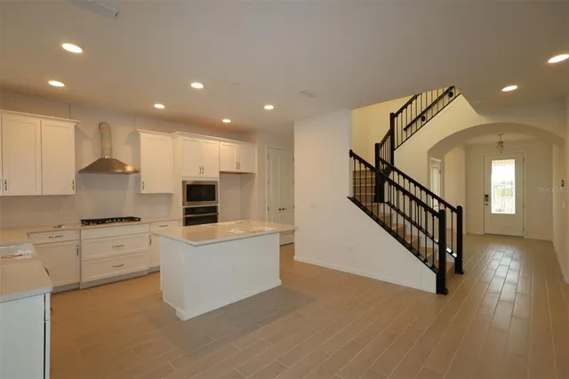 a kitchen with white cabinets and stainless steel appliances