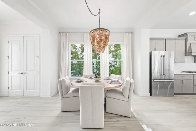 a dining room with furniture large windows a chandelier