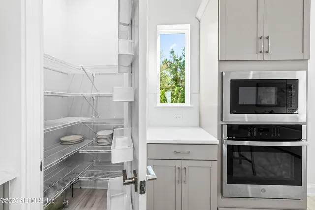 a kitchen with a stove and white cabinets
