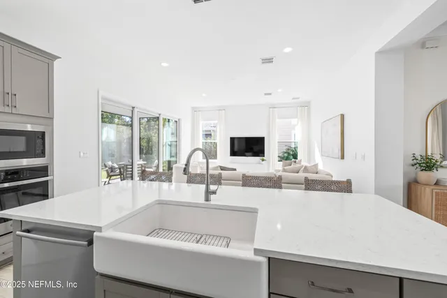 a view of living room with granite countertop furniture and a flat screen tv