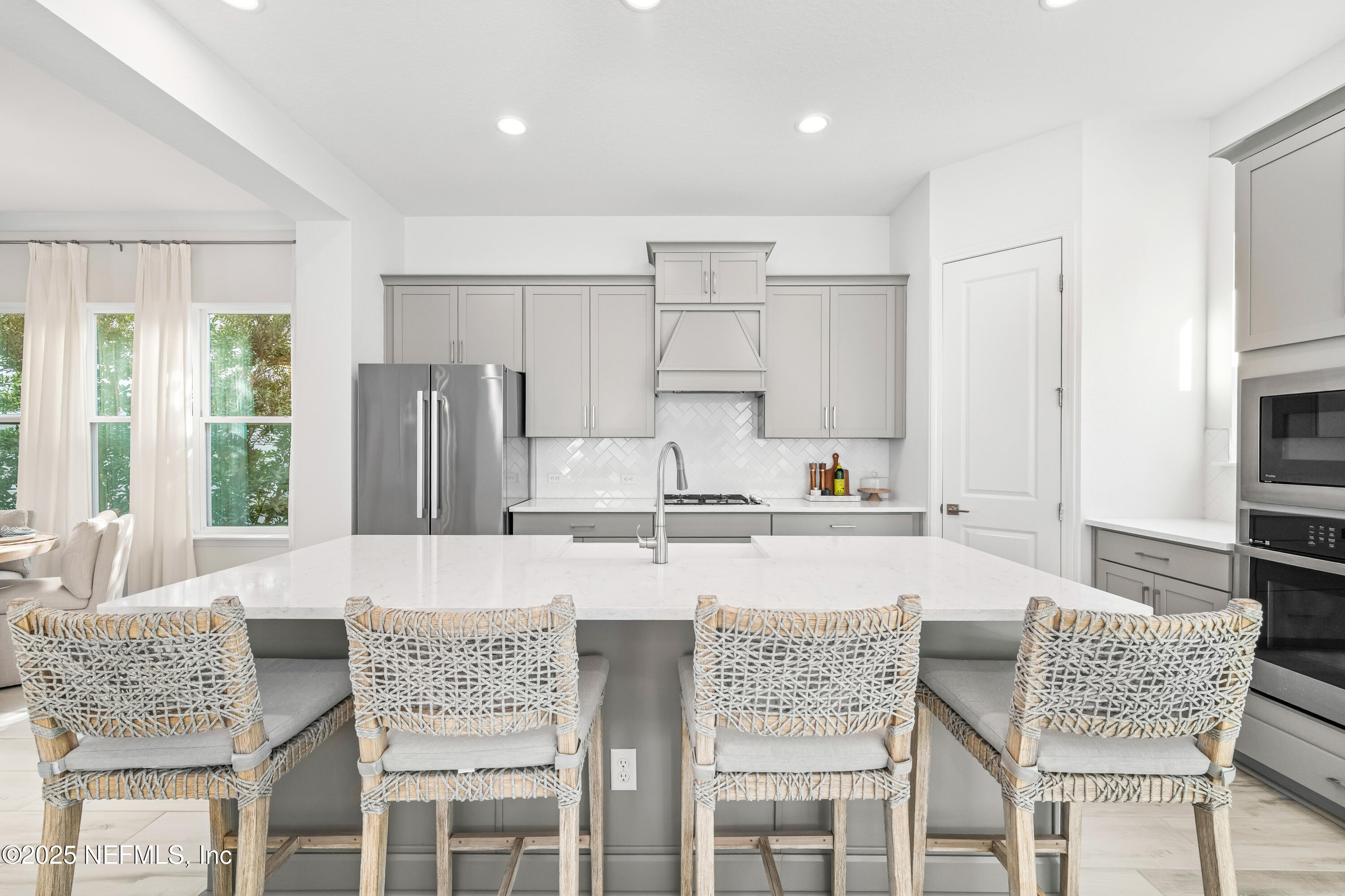 10459 Innovation Way Jacksonville, FL 32256 - Photo 19 of 54 a kitchen with granite countertop white cabinets and stainless steel appliances