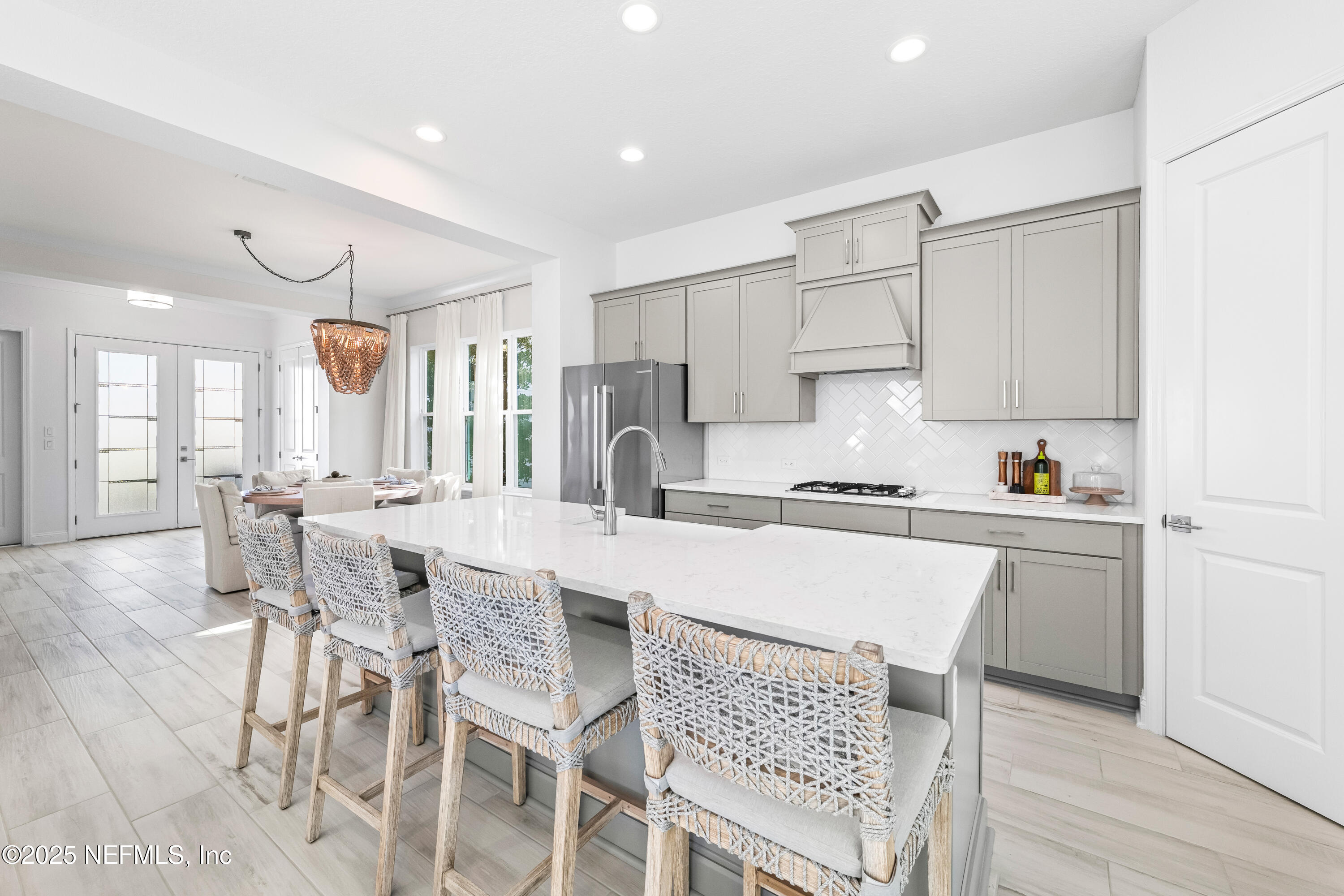 10459 Innovation Way Jacksonville, FL 32256 - Photo 20 of 54 a kitchen with a table chairs a sink dishwasher and cabinets with wooden floor