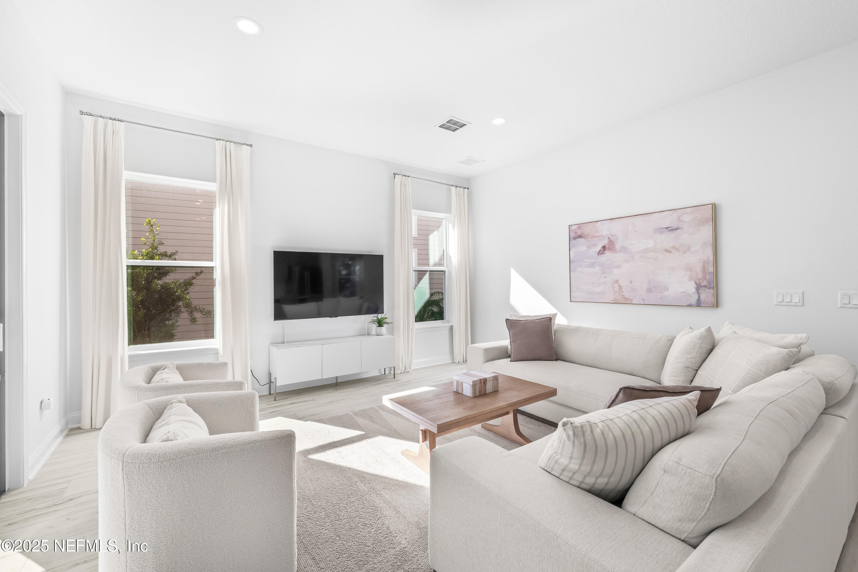10459 Innovation Way Jacksonville, FL 32256 - Photo 22 of 54 a living room with furniture and a flat screen tv