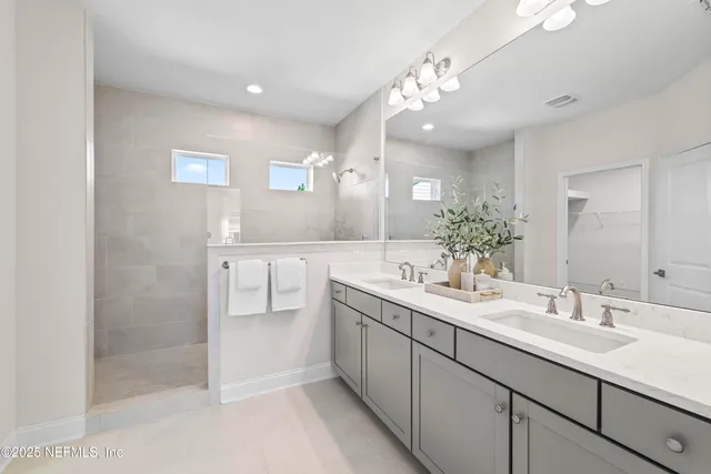 a bathroom with a sink double vanity and a mirror