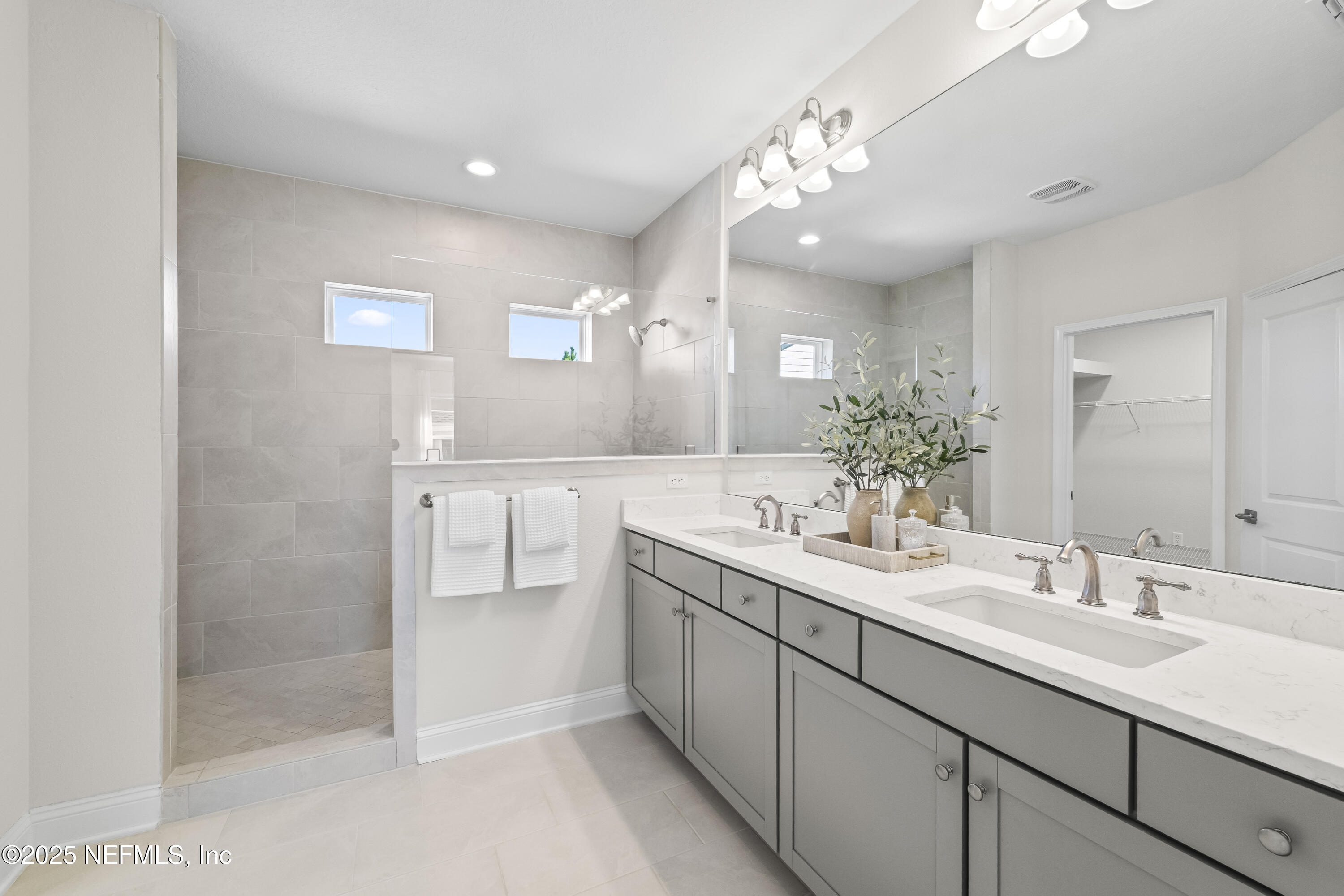 10459 Innovation Way Jacksonville, FL 32256 - Photo 31 of 54 a bathroom with a sink double vanity and a mirror