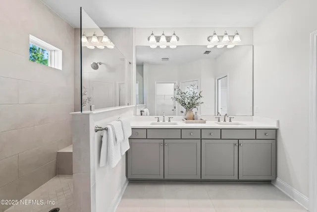 a bathroom with a sink vanity and a mirror