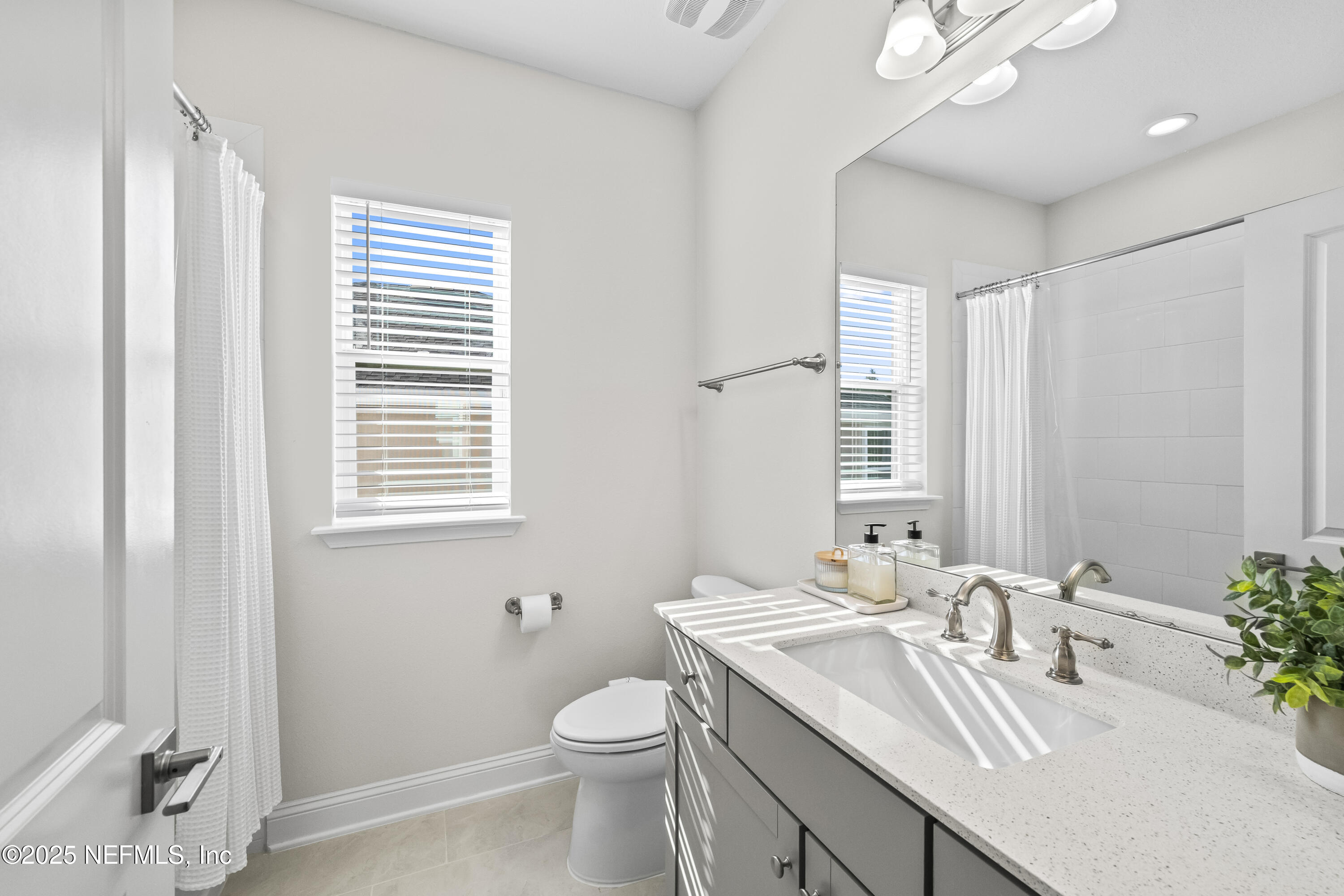 10459 Innovation Way Jacksonville, FL 32256 - Photo 39 of 54 a bathroom with a granite countertop sink toilet and mirror