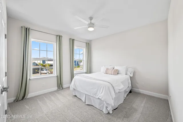 a bedroom with a balcony a bed and a window