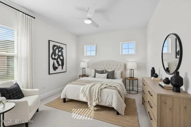 a bedroom with a bed a mirror and furniture