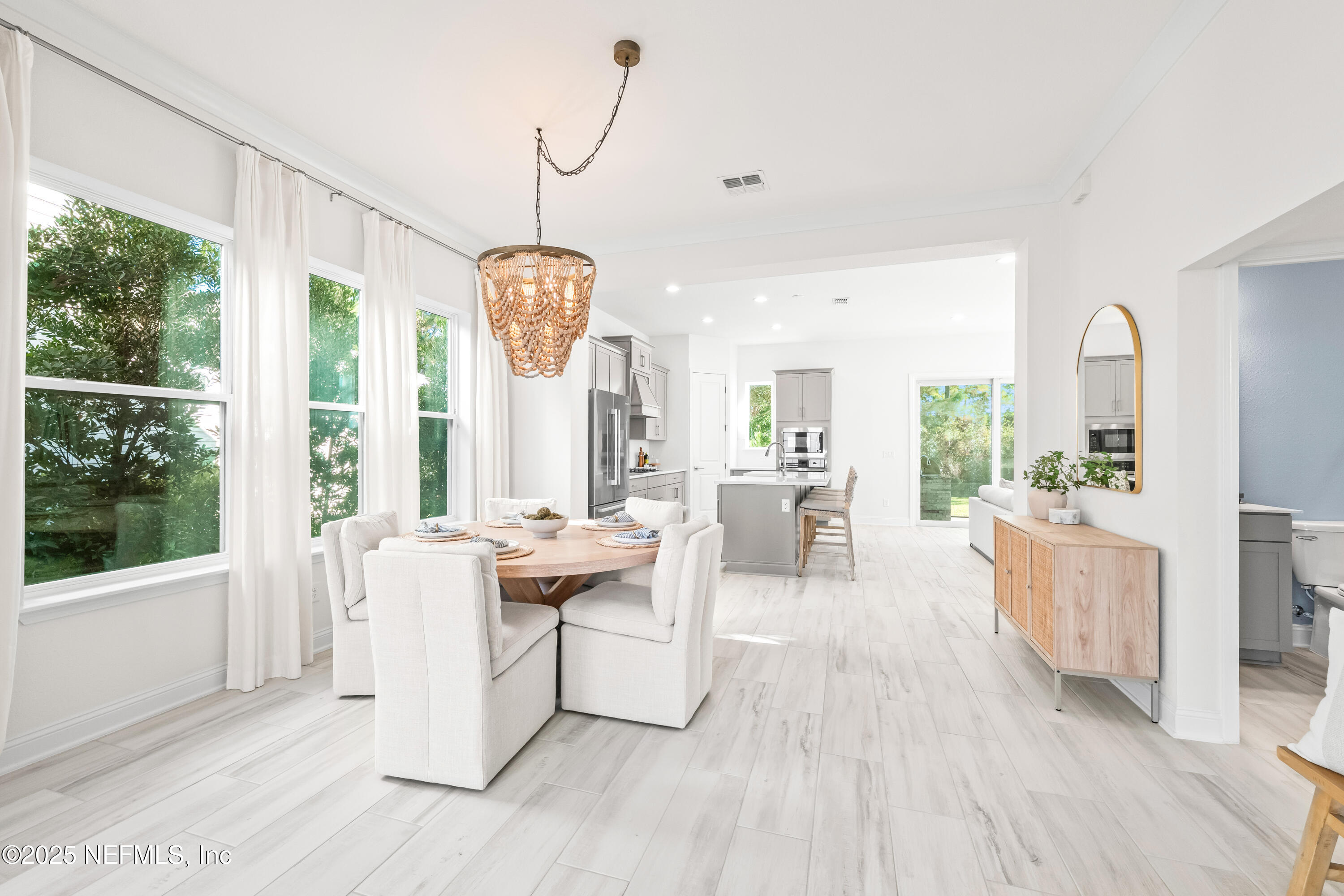 10459 Innovation Way Jacksonville, FL 32256 - Photo 6 of 54 a living room with furniture a large window and wooden floor