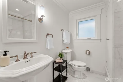 a bathroom with a sink a toilet and mirror