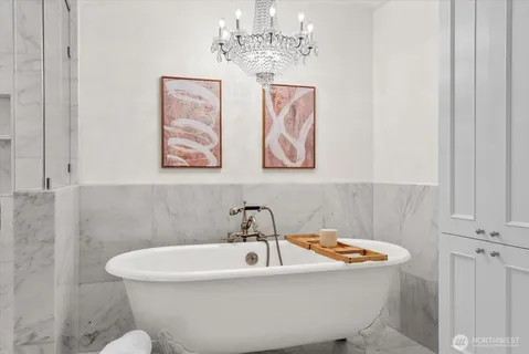 a white bath tub sitting next to a white sink