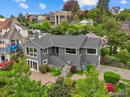 aerial view of a house with a yard and potted plants