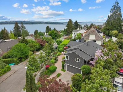 an aerial view of a house with garden space and ocean view