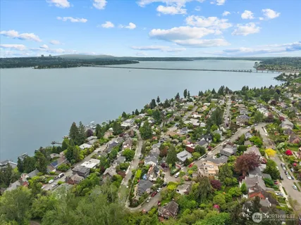 an aerial view of residential houses with outdoor space and street view