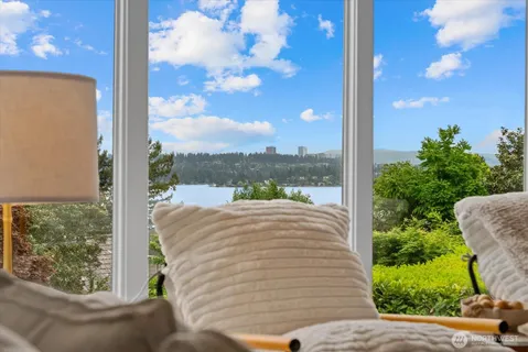 a view of a porch with a floor to ceiling window next to a yard