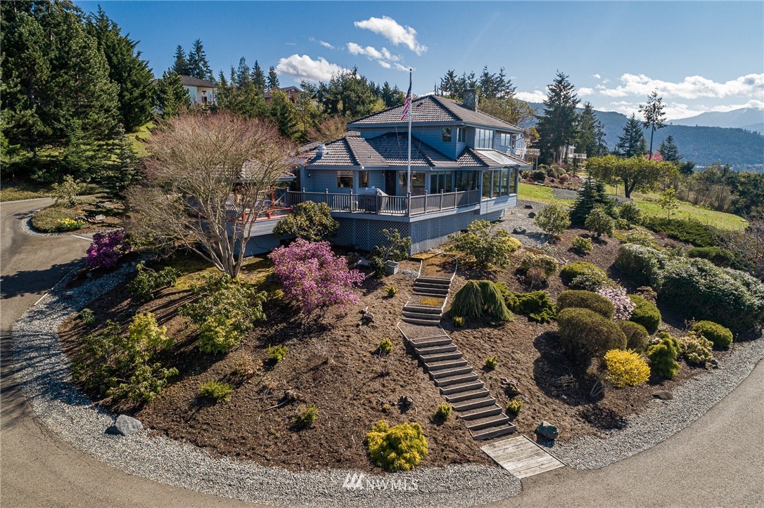 543 Ravens Ridge Road Sequim, WA 98382 - Photo 2 of 40 a view of a house with a yard and garden