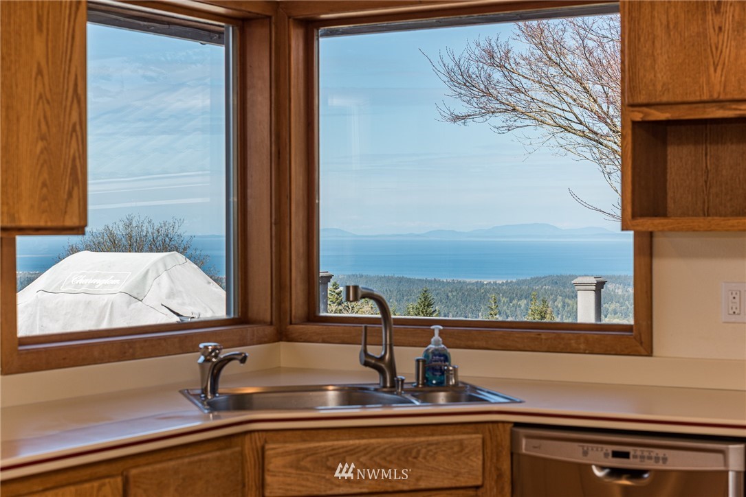 543 Ravens Ridge Road Sequim, WA 98382 - Photo 14 of 40 a kitchen with a sink and a window