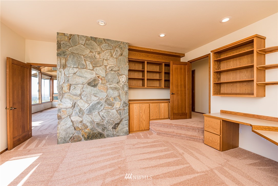 543 Ravens Ridge Road Sequim, WA 98382 - Photo 20 of 40 a view of empty room with a fireplace and cabinet