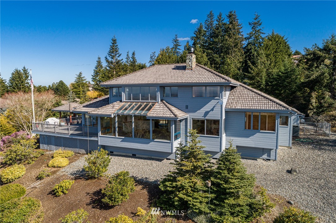 543 Ravens Ridge Road Sequim, WA 98382 - Photo 3 of 40 a front view of a house with a yard