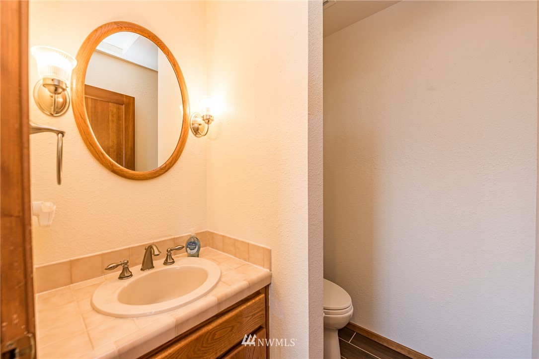 543 Ravens Ridge Road Sequim, WA 98382 - Photo 25 of 40 a bathroom with a sink and a mirror
