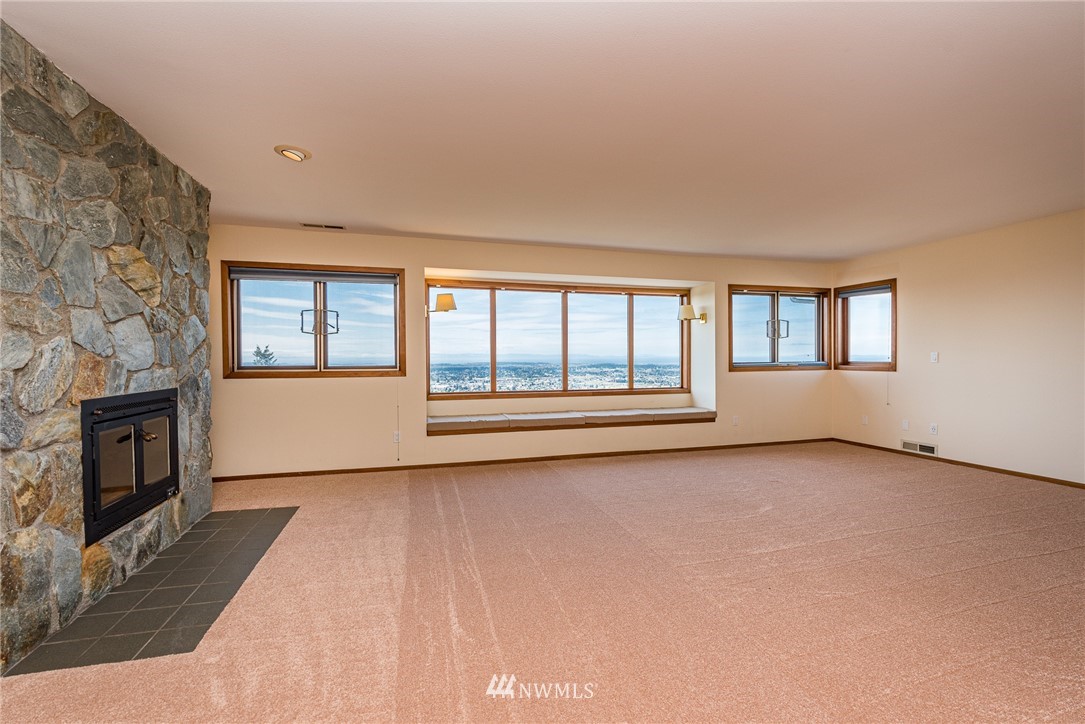 543 Ravens Ridge Road Sequim, WA 98382 - Photo 30 of 40 a view of an empty room with a fireplace and a window