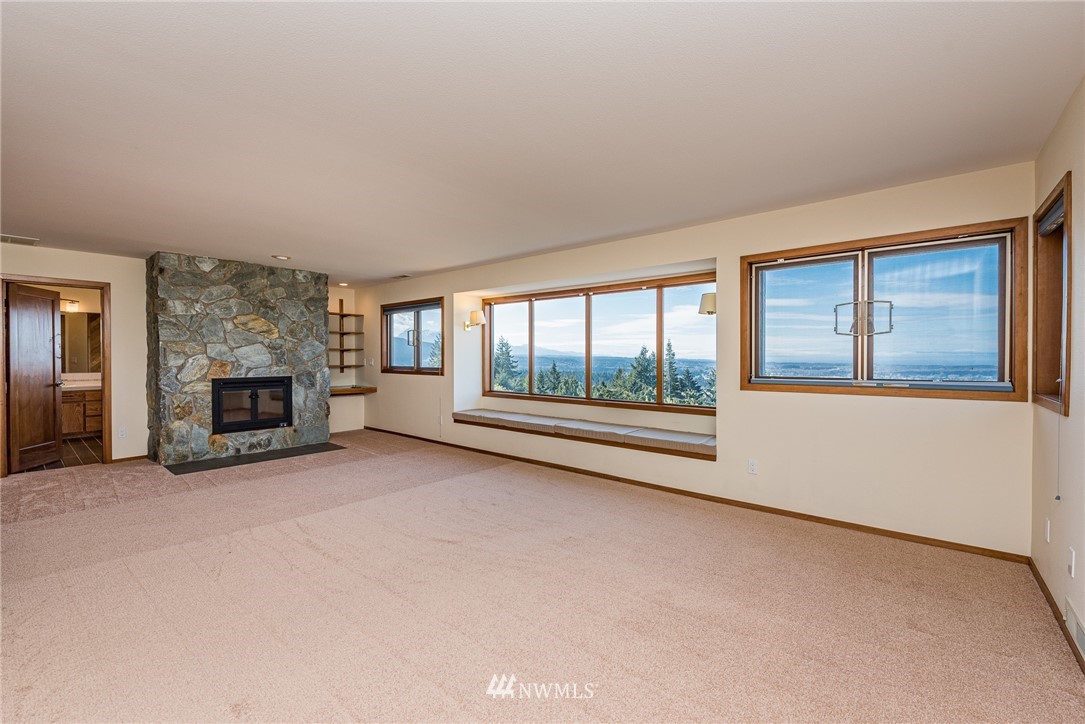 543 Ravens Ridge Road Sequim, WA 98382 - Photo 31 of 40 wooden floor fireplace and windows in an empty room
