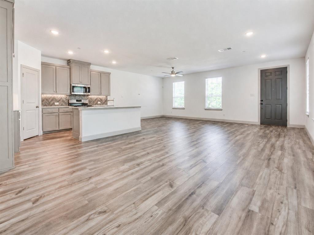 8913 Swallowtail Street Frisco, TX 75035 - Photo 5 of 38 a view of kitchen with wooden floor and electronic appliances