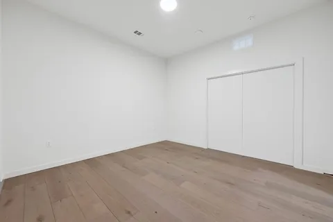 a view of an empty room with a closet
