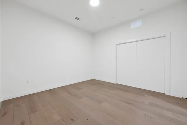 a view of an empty room with a closet