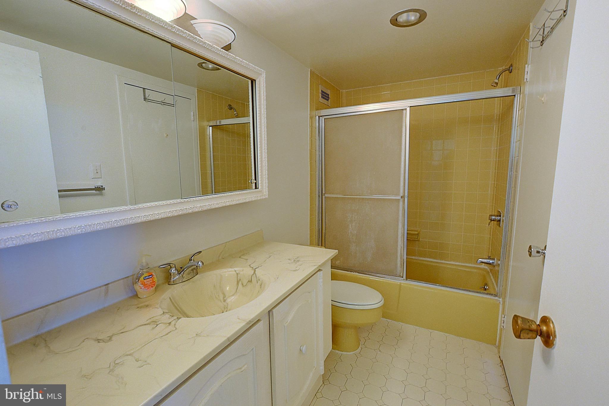 5225 Pooks Hill Road, Unit 1717S Bethesda, MD 20814 - Photo 5 of 12 a bathroom with a sink toilet and shower