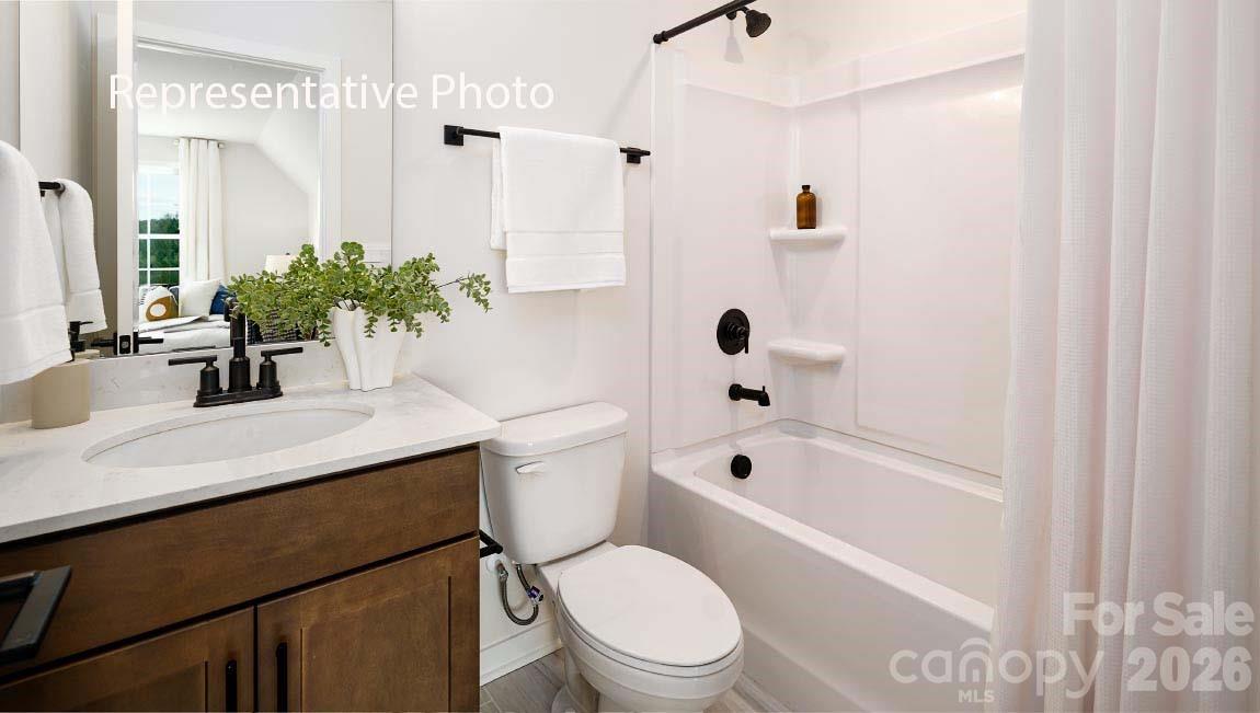 3117 Spring Iris Drive Denver, NC 28037 - Photo 12 of 42 a bathroom with a sink a toilet a mirror a vanity and shower