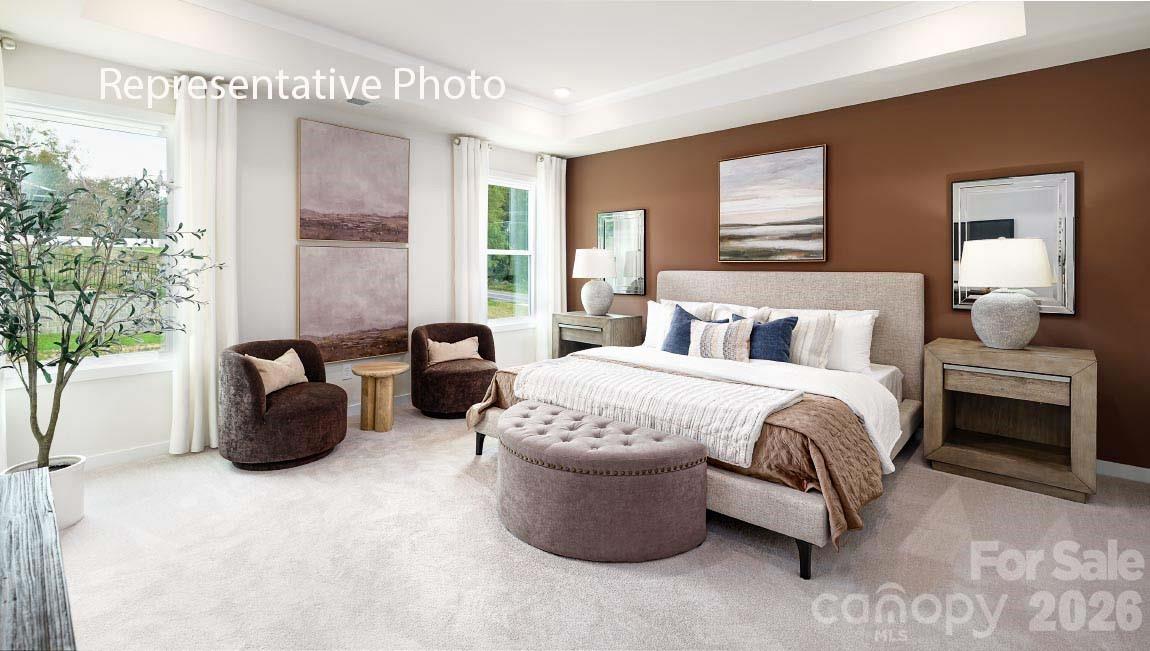 3117 Spring Iris Drive Denver, NC 28037 - Photo 13 of 42 a bedroom with a bed and large windows