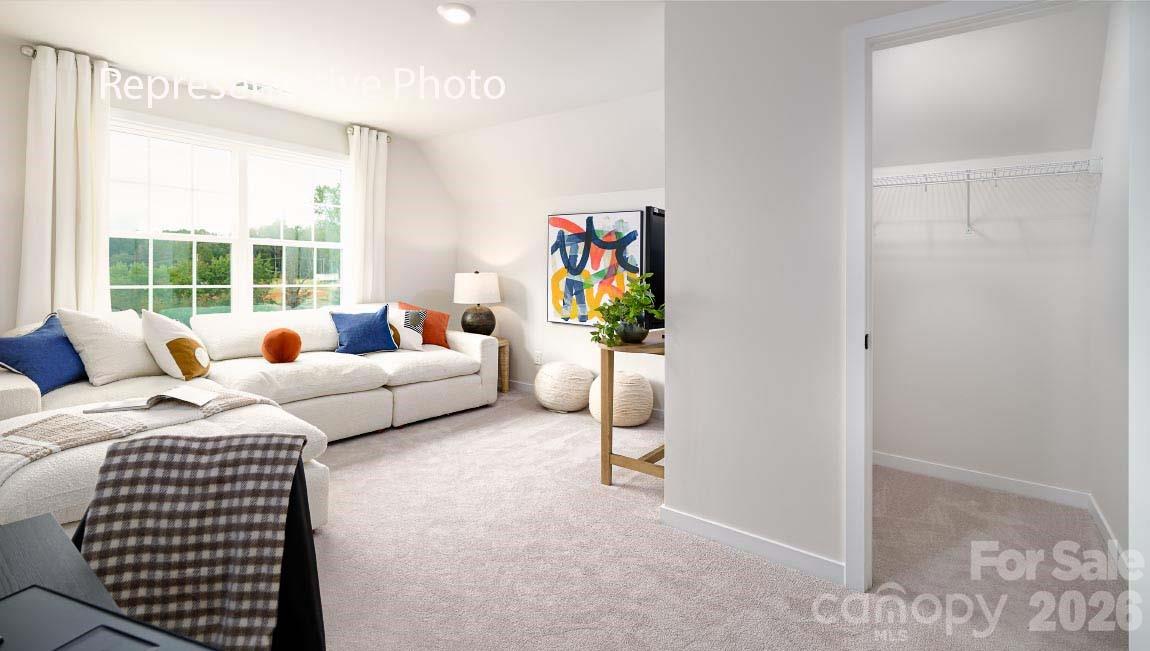 3117 Spring Iris Drive Denver, NC 28037 - Photo 24 of 42 a bedroom with a bed and a couch