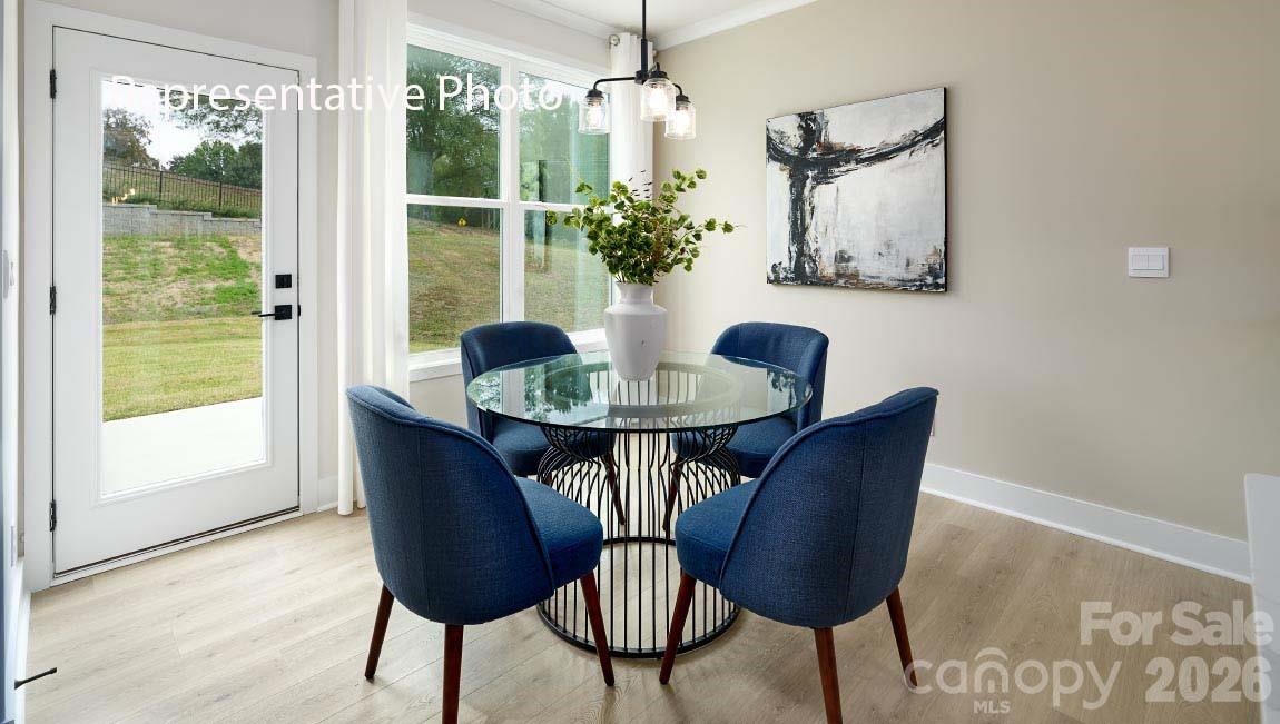 3117 Spring Iris Drive Denver, NC 28037 - Photo 27 of 42 a view of a dining room with furniture window and wooden floor