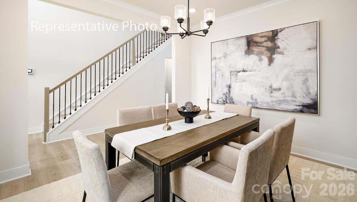 3117 Spring Iris Drive Denver, NC 28037 - Photo 29 of 42 a view of a dining room with furniture and a chandelier