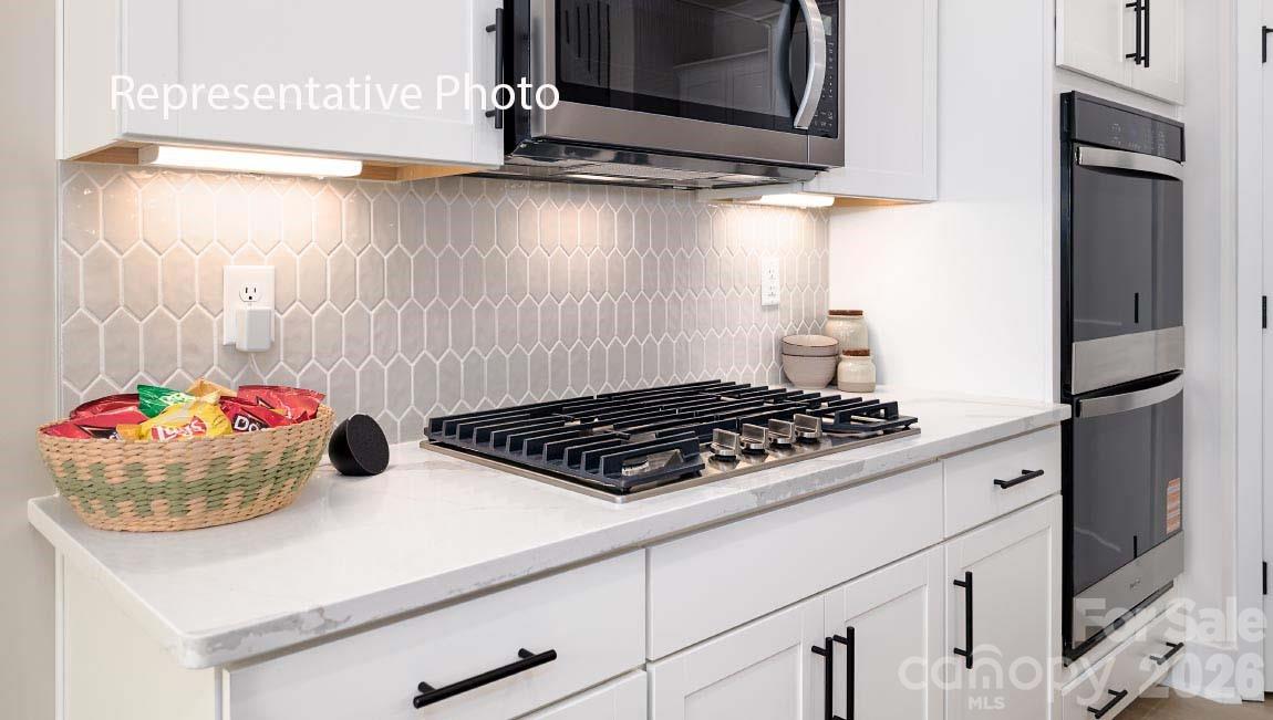 3117 Spring Iris Drive Denver, NC 28037 - Photo 39 of 42 a kitchen with a stove and a refrigerator