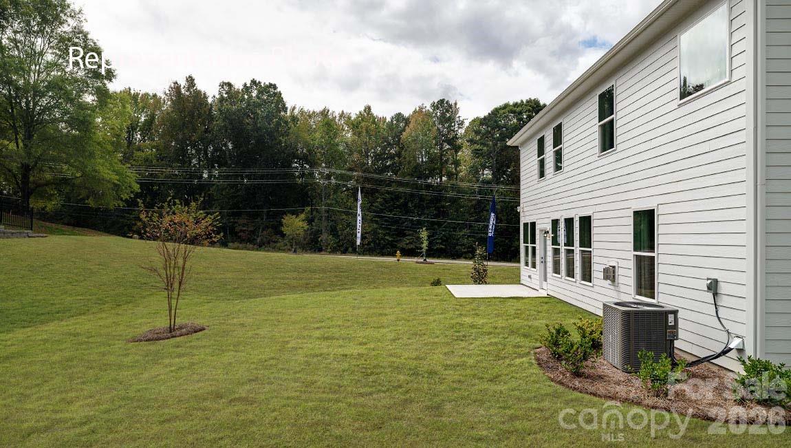 3117 Spring Iris Drive Denver, NC 28037 - Photo 6 of 42 a swimming pool with lots of tress in the background