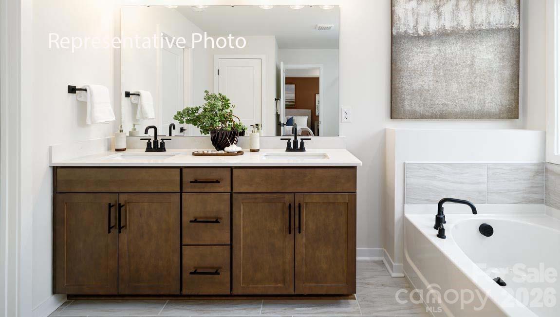 3117 Spring Iris Drive Denver, NC 28037 - Photo 8 of 42 a bathroom with a sink tub double vanity and mirror